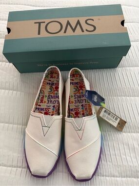 TOMS White Canvas Slip-Ons with Rainbow Pride Insole